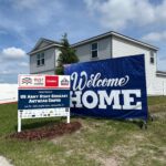 Beautiful new home with big Welcome Home sign in front yard