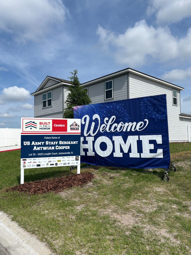 Beautiful new home with big Welcome Home sign in front yard