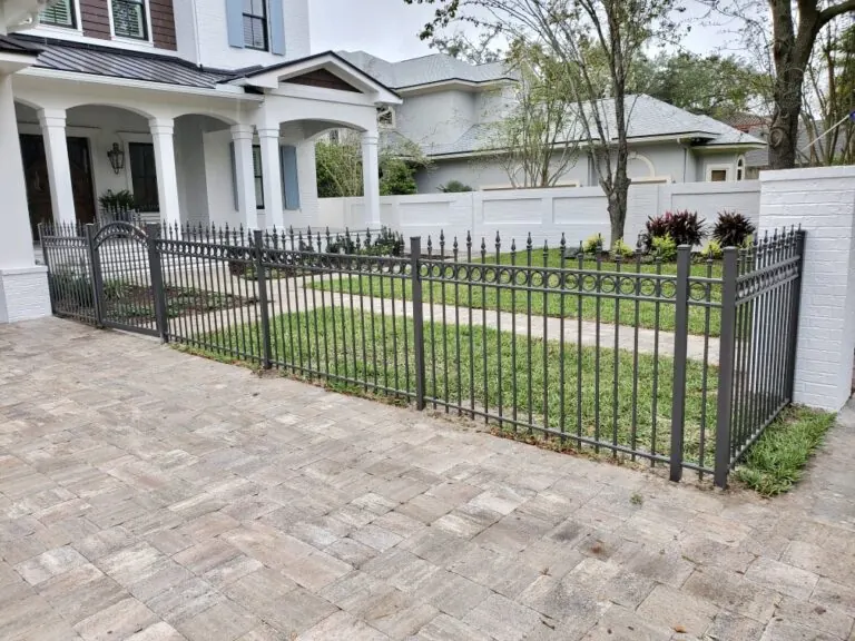 Beautiful aluminum fence along a driveway and front yard area.