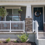 Front porch with white railing.