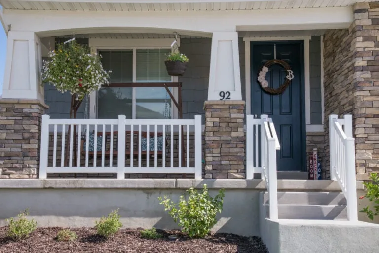 Front porch with white railing.