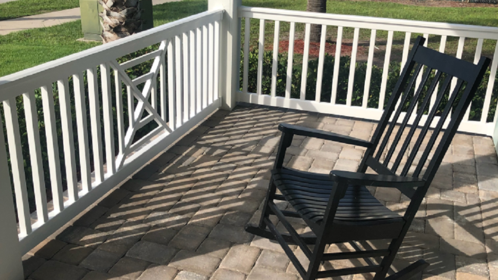 Rocking chair on porch with white railings