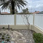 Pretty white vinyl fence near walkway.