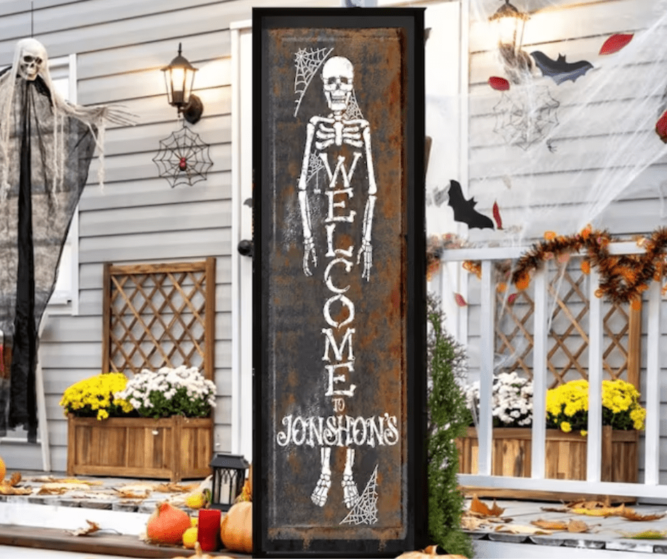 A house with Halloween decorations on the door and porch.