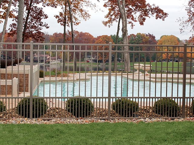 Backyard pool with puppy fence surrounding