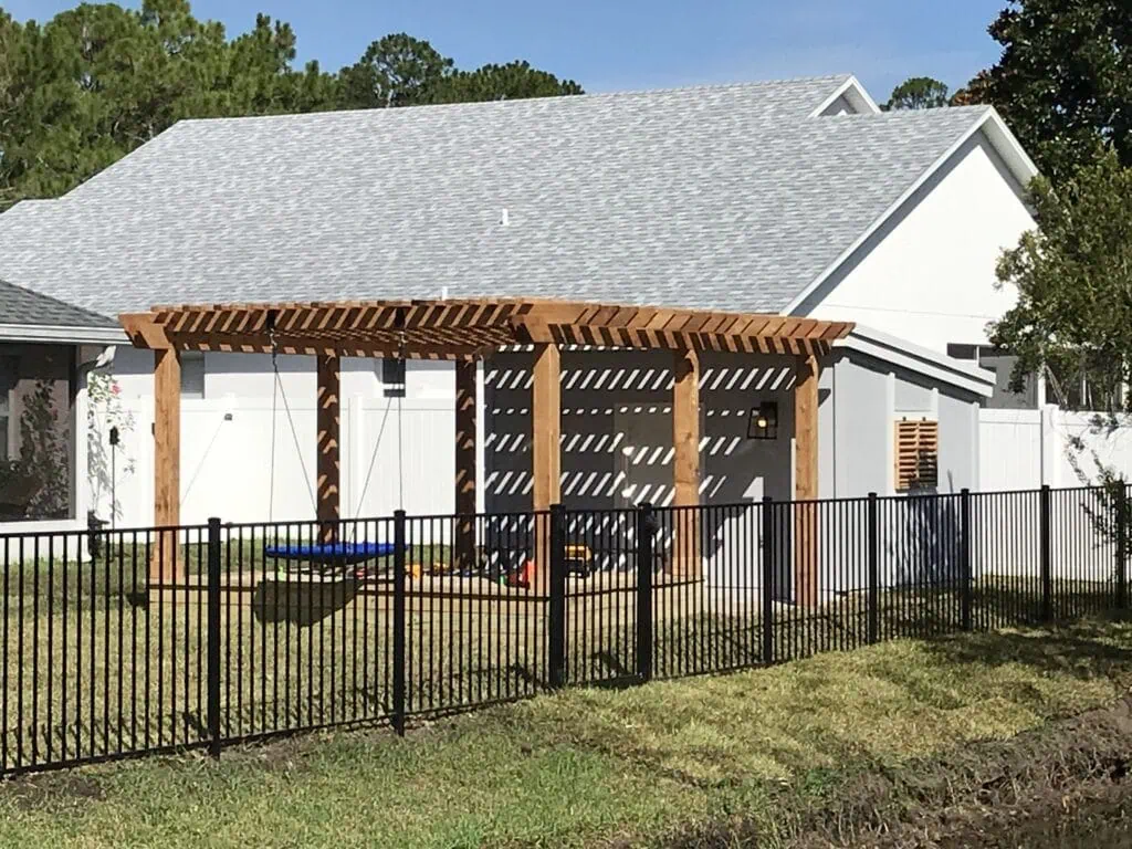 Suburban house with black aluminum backyard fence
