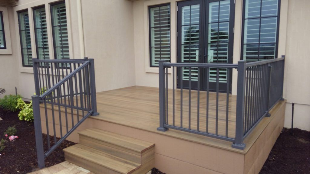 Small front porch with railing and handrail.