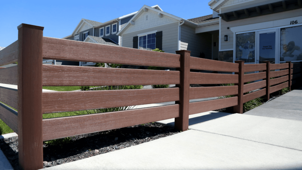 Pretty brown vinyl fence along a neighborhood sidewalk.