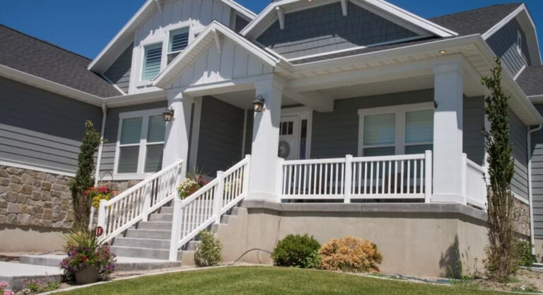 Front of house with porch and railings.