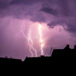 Lightning in the sky over houses