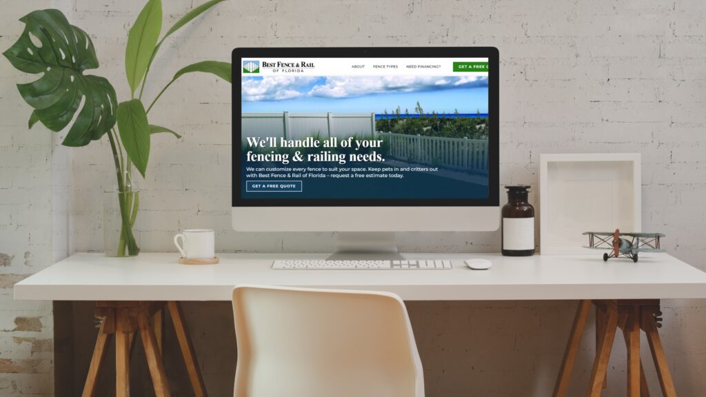 Desk with computer showing Best Fence & Rail website on the screen