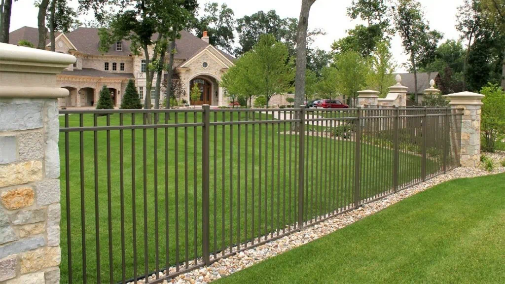 Beutiful front yard of home with a custom aluminum fence.